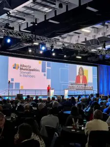 President Andrea Sandmaier speaks on stage at the Alberta Municipalities Convention, September 2024.