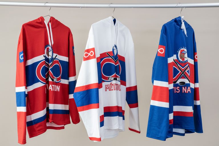 Voyageur Hockey Jersey Hoodie shown in 3 colours, red, white and blue